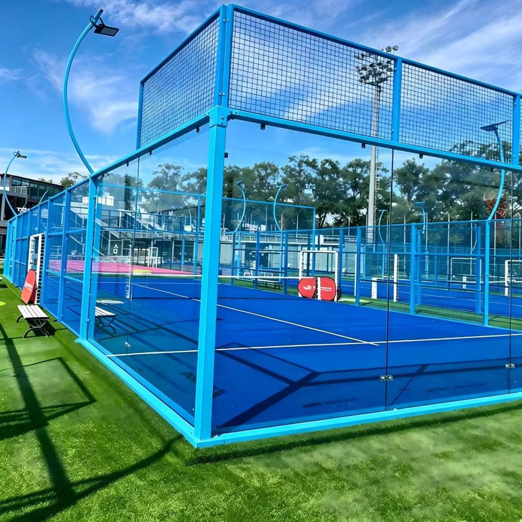 Blue-framed outdoor padel court with glass walls