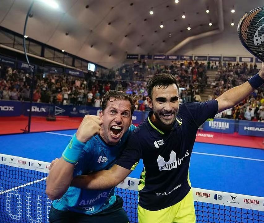 Two padel players celebrating after a match win