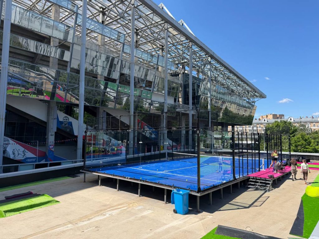 A panoramic padel court installed next to a modern building