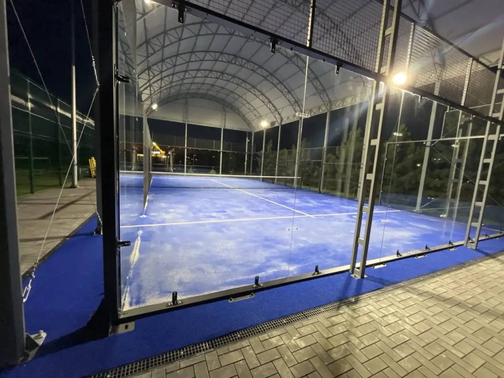 An indoor covered padel court with fabric roof and LED lighting