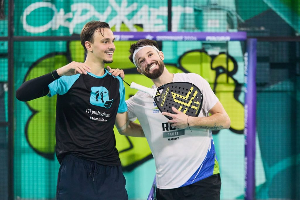 Two players holding their padel rackets together