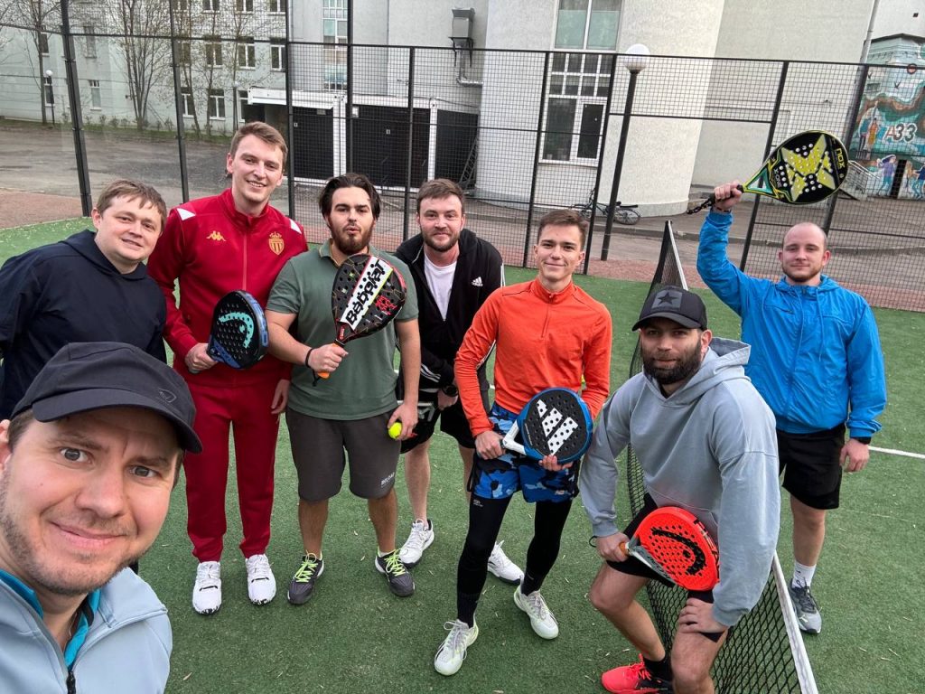 Padel players taking a group selfie after a match